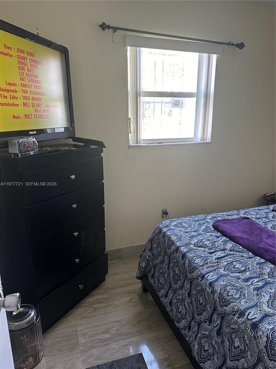 10761 Southwest 221st Street Miami, FL 33170 - Photo 17 of 32 a bedroom with a bed and a window