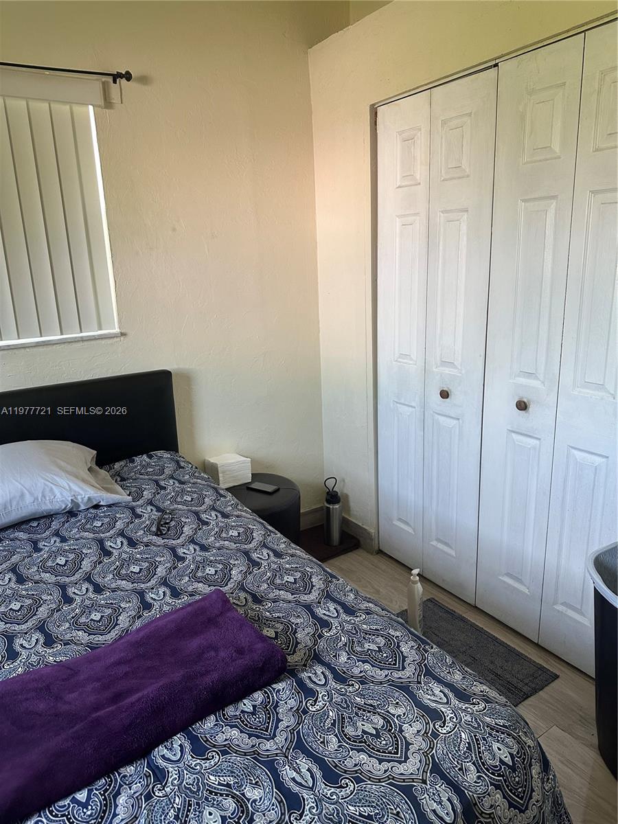 10761 Southwest 221st Street Miami, FL 33170 - Photo 18 of 32 a bedroom with a bed and a window