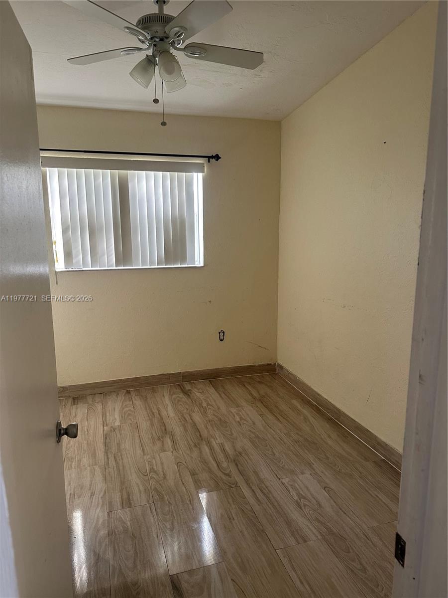 10761 Southwest 221st Street Miami, FL 33170 - Photo 19 of 32 a view of an empty room and wooden floor
