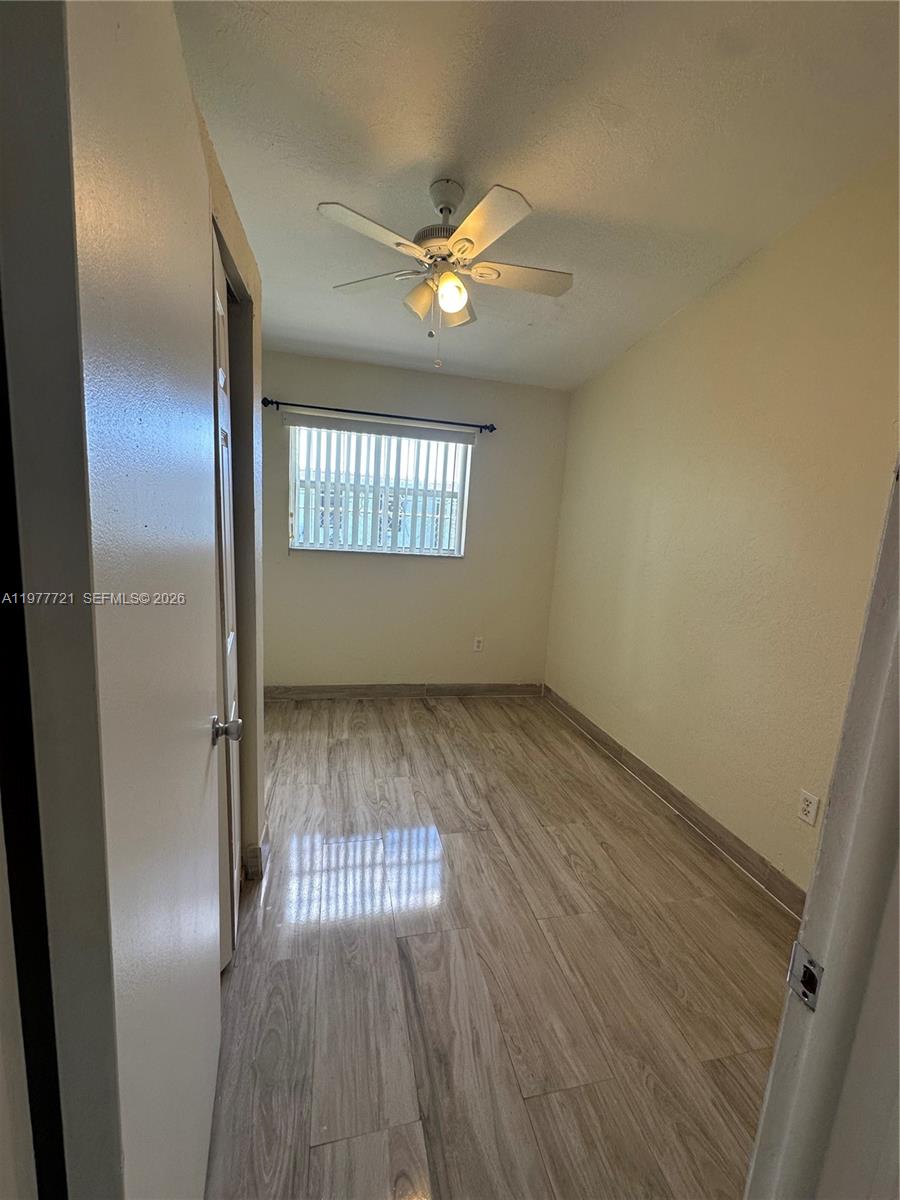10761 Southwest 221st Street Miami, FL 33170 - Photo 23 of 32 a view of empty room with wooden floor