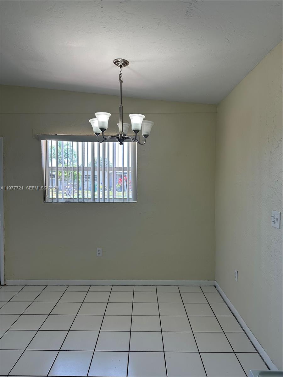 10761 Southwest 221st Street Miami, FL 33170 - Photo 28 of 32 an empty room with chandelier fan