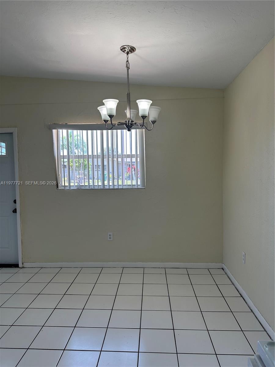 10761 Southwest 221st Street Miami, FL 33170 - Photo 31 of 32 an empty room that has a mirror and a sink