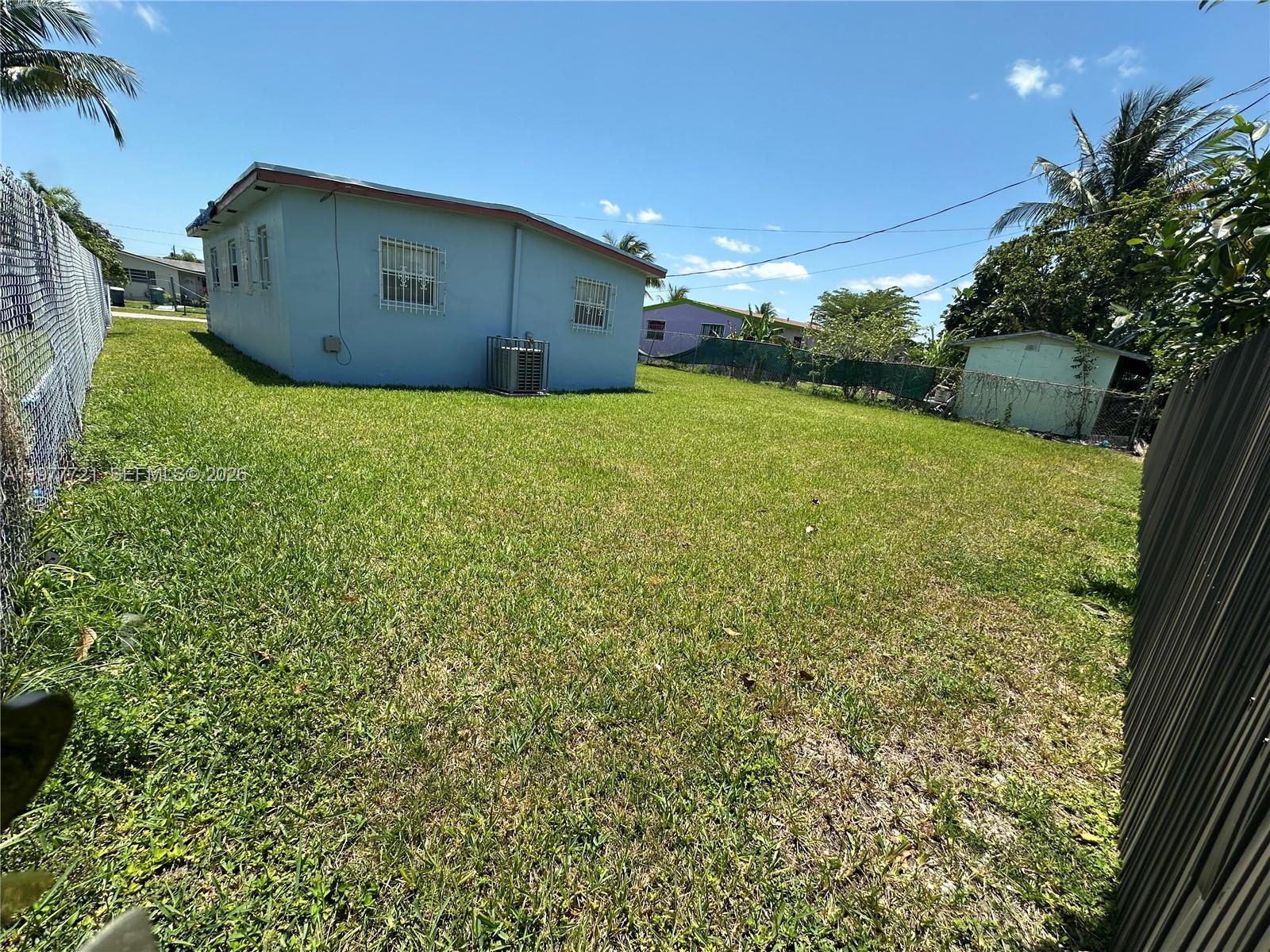 10761 Southwest 221st Street Miami, FL 33170 - Photo 5 of 32 a view of a big yard with plants and large trees