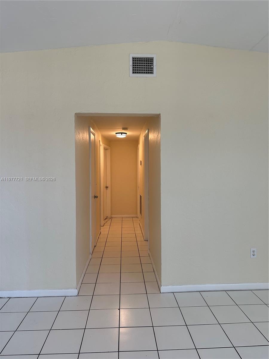 10761 Southwest 221st Street Miami, FL 33170 - Photo 6 of 32 a view of a livingroom and an empty room