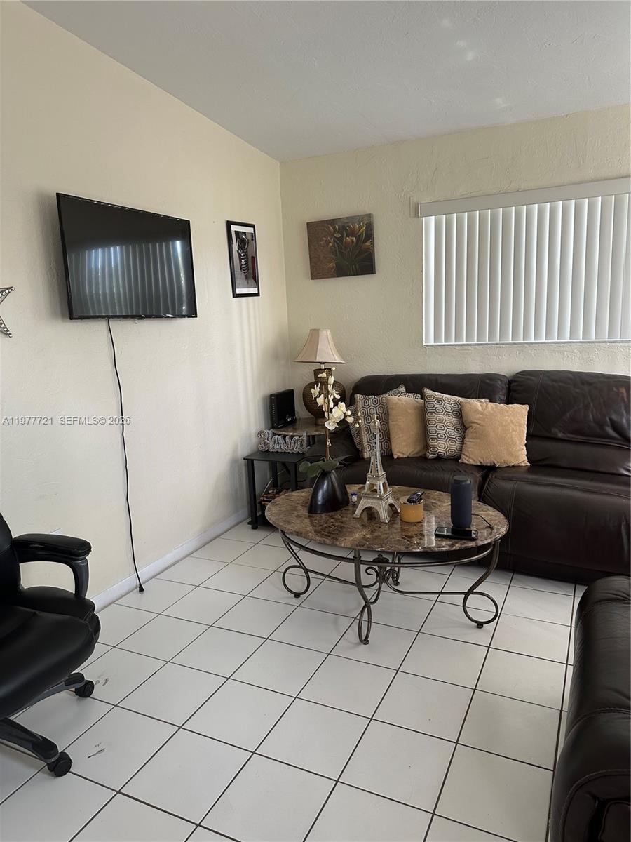 10761 Southwest 221st Street Miami, FL 33170 - Photo 8 of 32 a living room with furniture and a couch
