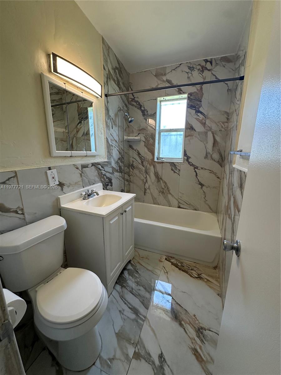 10761 Southwest 221st Street Miami, FL 33170 - Photo 9 of 32 a bathroom with a sink toilet and shower