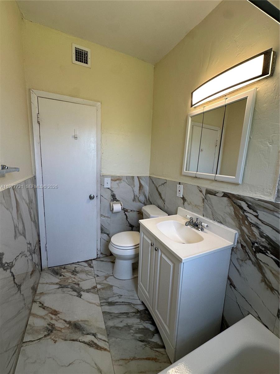 10761 Southwest 221st Street Miami, FL 33170 - Photo 10 of 32 a bathroom with a sink toilet and shower