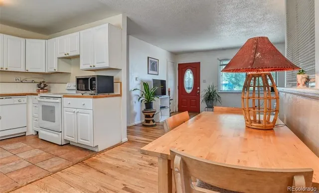 a kitchen with a sink a stove and cabinets