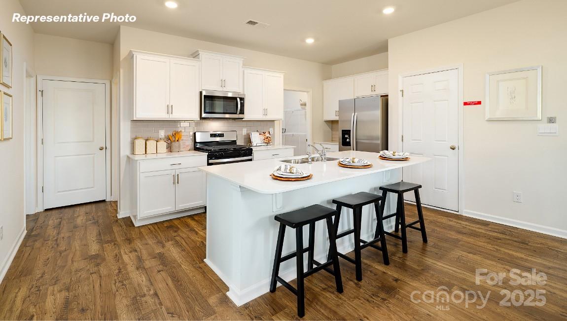 3844 Maxwell Henry Lane Northwest Conover, NC 28613 - Photo 6 of 30 a kitchen with stainless steel appliances a dining table chairs microwave and sink