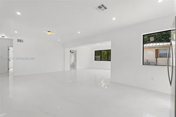 a view of an empty room with a window