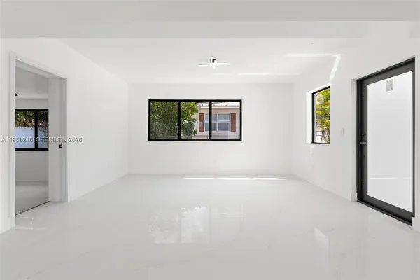 an empty room with windows and closet