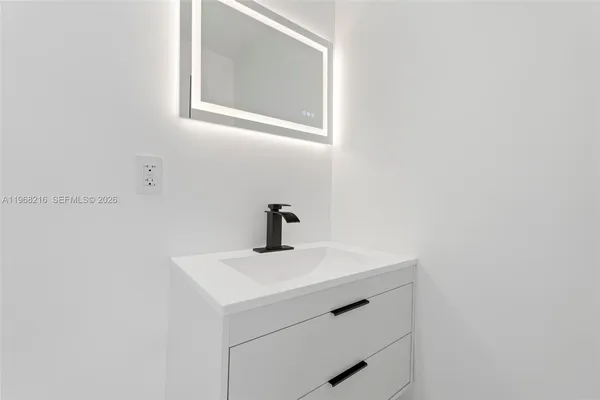 a bathroom with a sink and a mirror