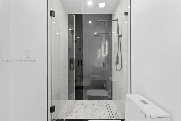 a bathroom with a shower and sink