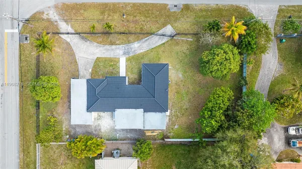 an aerial view of residential house with outdoor space and swimming pool
