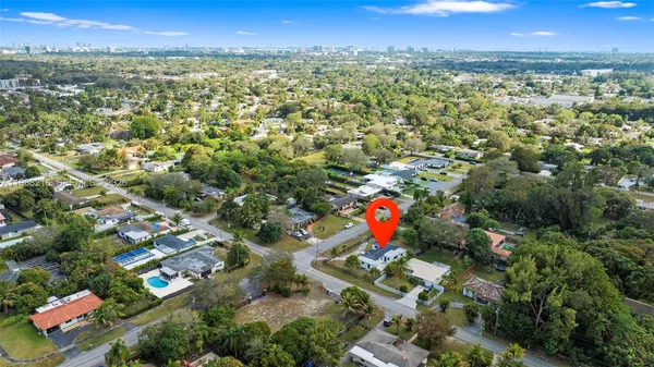 an aerial view of residential houses with outdoor and green space