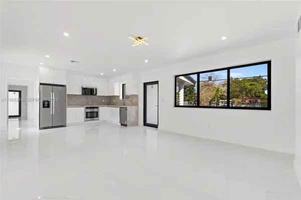 a view of a kitchen with a sink and a window