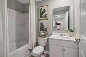 a bathroom with a sink a toilet a mirror and shower