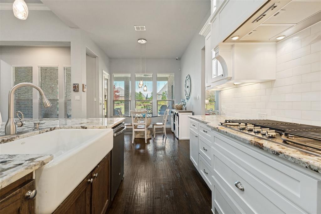 506 Life Spring Drive Rockwall, TX 75087 - Photo 11 of 36 a large kitchen with sink stove top oven and cabinets