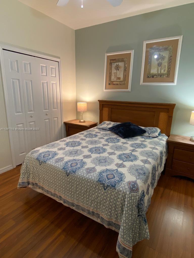 8570 Bay Lilly Loop Kissimmee, FL 34747 - Photo 11 of 36 a bedroom with a bed and a night stand
