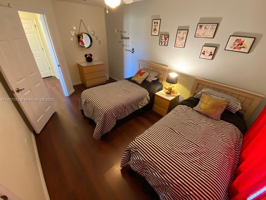 8570 Bay Lilly Loop Kissimmee, FL 34747 - Photo 17 of 36 a bedroom with two beds and a dresser