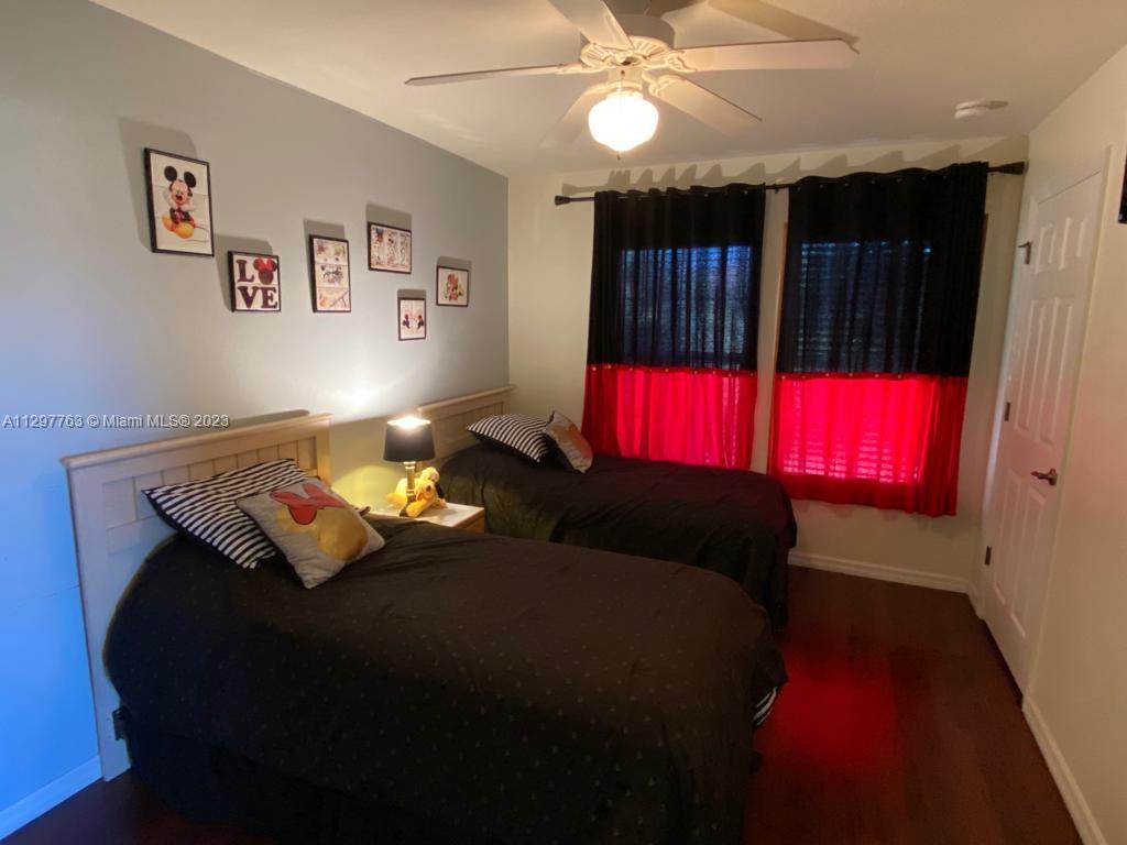 8570 Bay Lilly Loop Kissimmee, FL 34747 - Photo 18 of 36 a bedroom with a bed and a lamp