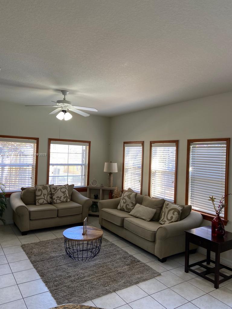8570 Bay Lilly Loop Kissimmee, FL 34747 - Photo 2 of 36 a living room with furniture and a large window