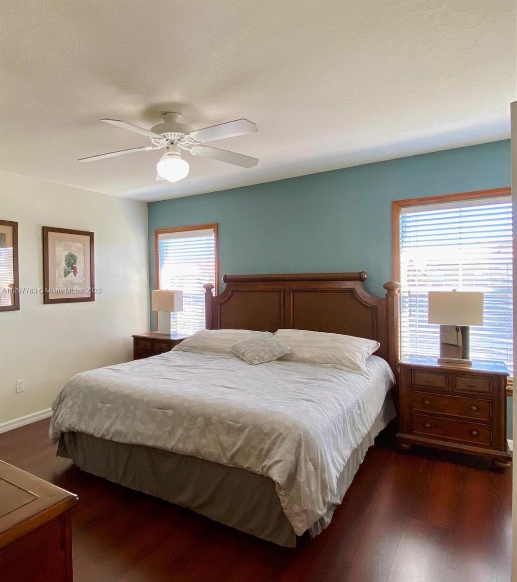 8570 Bay Lilly Loop Kissimmee, FL 34747 - Photo 22 of 36 a bedroom with a bed and a large window