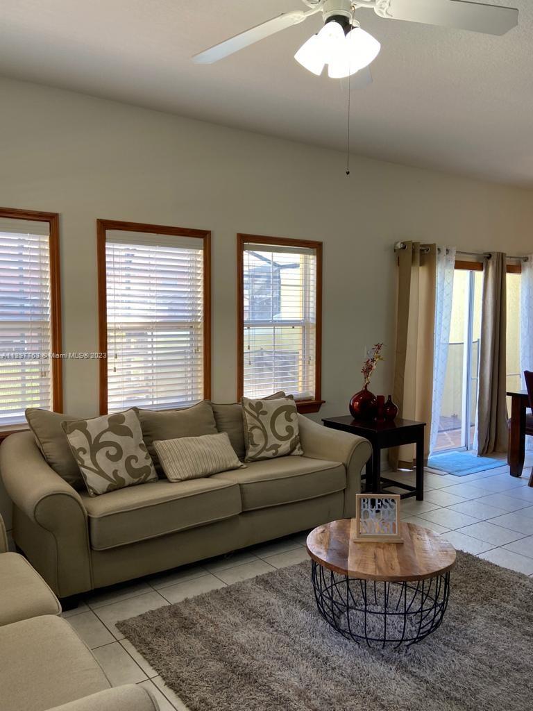 8570 Bay Lilly Loop Kissimmee, FL 34747 - Photo 3 of 36 a living room with furniture and a large window