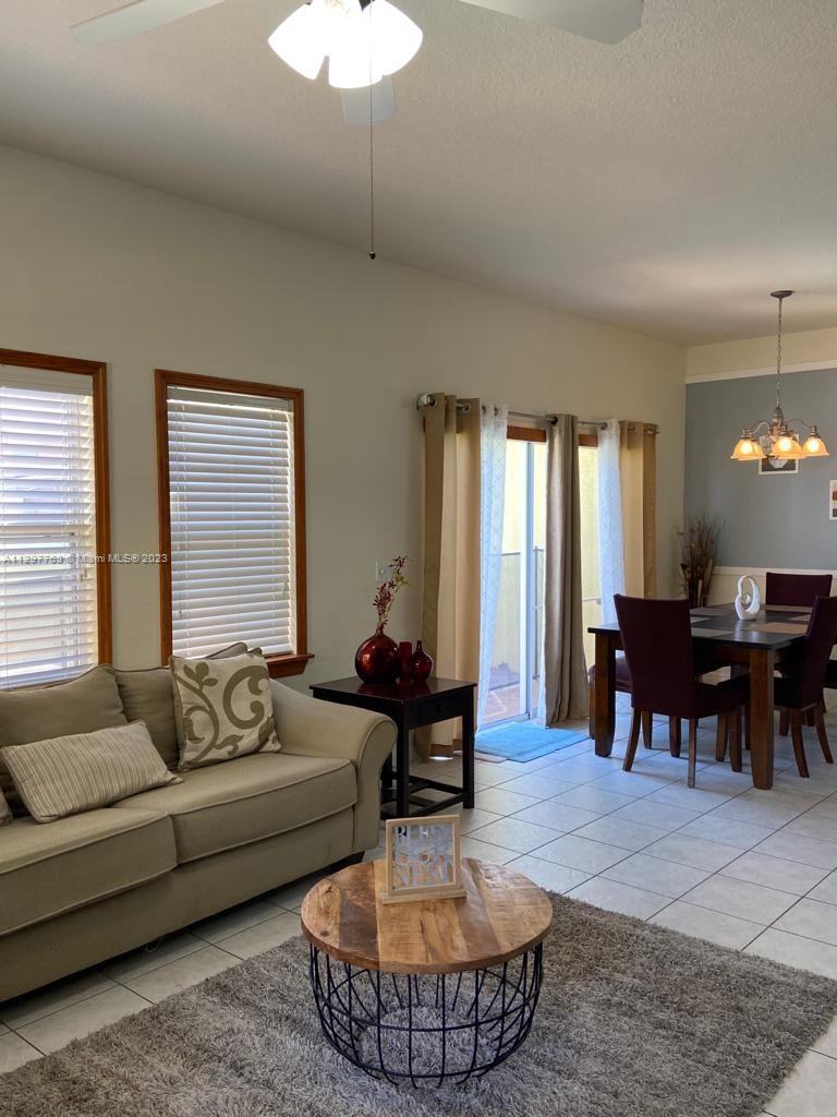 8570 Bay Lilly Loop Kissimmee, FL 34747 - Photo 5 of 36 a living room with furniture and a large window
