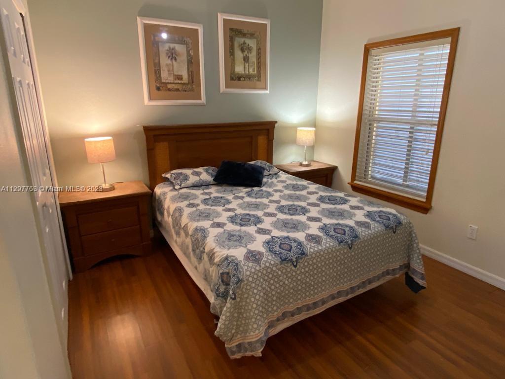 8570 Bay Lilly Loop Kissimmee, FL 34747 - Photo 10 of 36 a large bed sitting in a bedroom next to a lamp