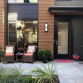 a view of backyard with outdoor seating and plants