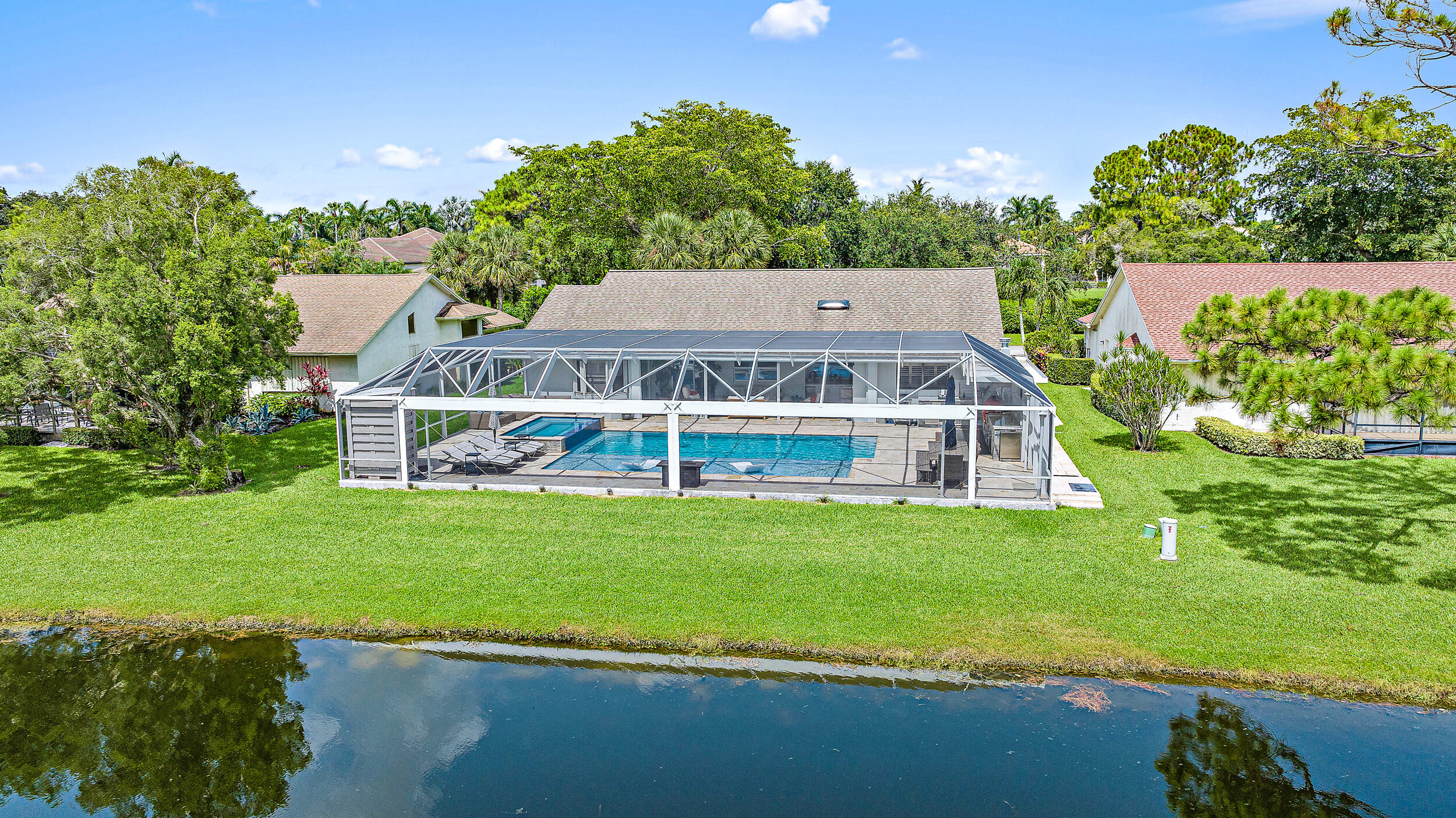 16730 Willow Creek Drive Delray Beach, FL 33484 - Photo 1 of 32 a view of a big house with a big yard and large trees