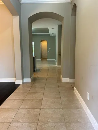 a view of a hallway to rooms