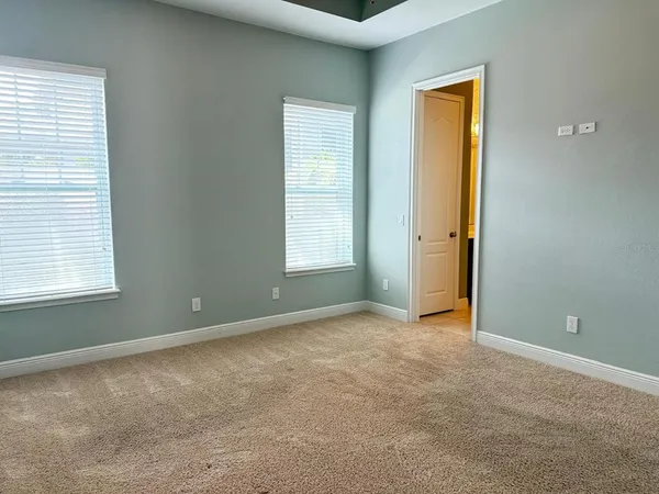 an empty room with windows and closet