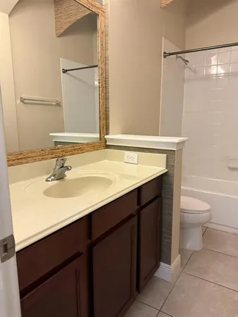 a bathroom with a sink vanity toilet and a mirror