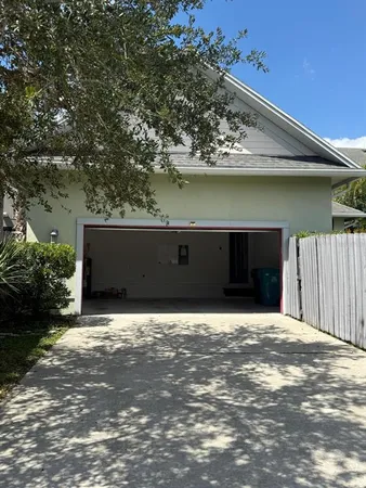 a view of a backyard with a garden and wooden fence
