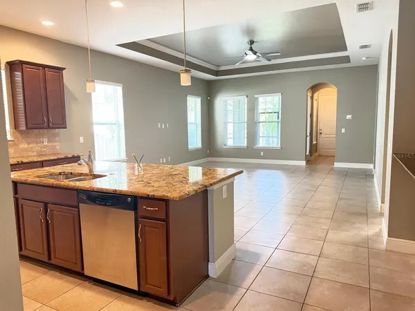 a large kitchen with kitchen island a sink stainless steel appliances and cabinets