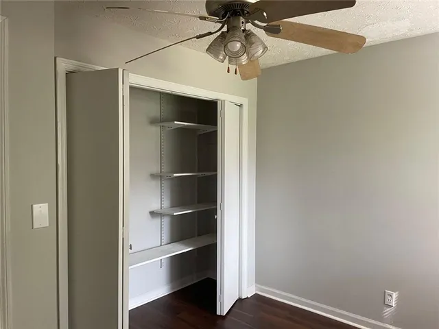 a view of wooden fence under a large tree