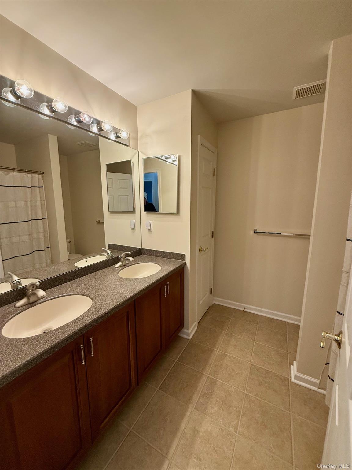 955 Huntington Drive Fishkill, NY 12524 - Photo 16 of 16 a spacious bathroom with a double vanity sink a mirror and a shower