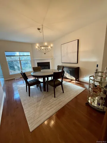 a dining room with furniture a rug and a chandelier