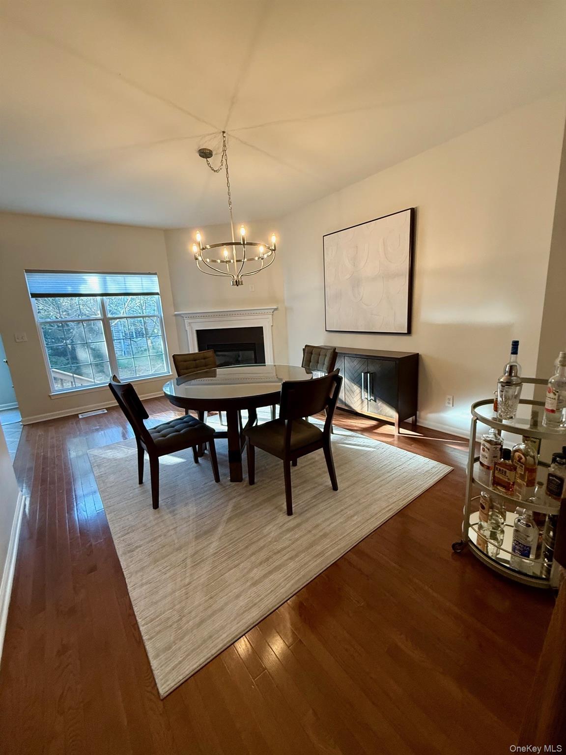 955 Huntington Drive Fishkill, NY 12524 - Photo 5 of 16 a dining room with furniture a rug and a chandelier
