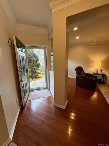 a view of a hallway with wooden floor and glass door