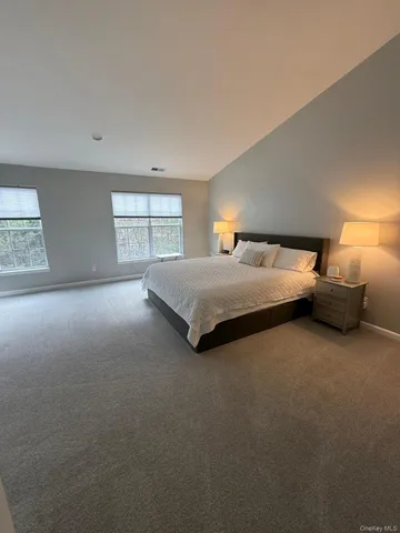 a spacious bedroom with a bed and window