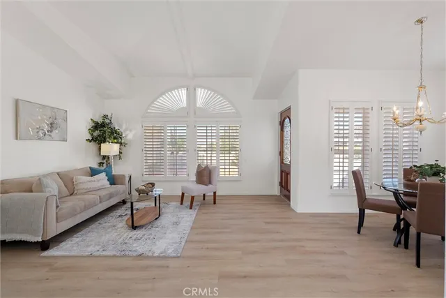 a living room with furniture floor to ceiling window and a table