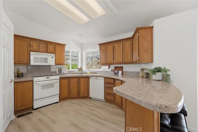 a kitchen with a stove a sink and a refrigerator