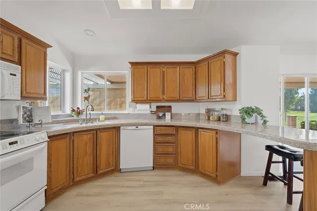 a kitchen with a sink cabinets and window