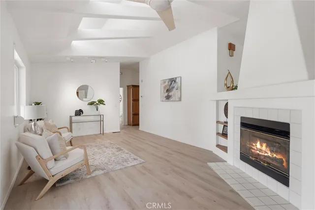 a living room with furniture a fireplace and a table