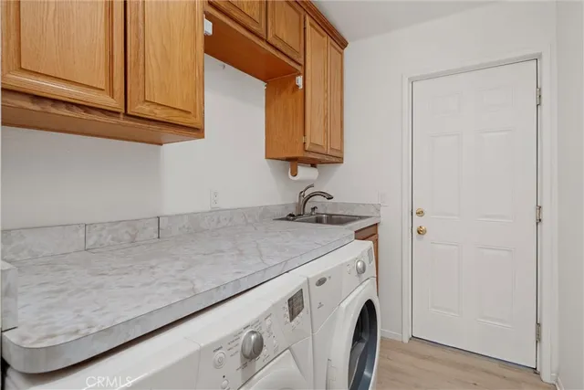 a utility room with sink dryer and washer