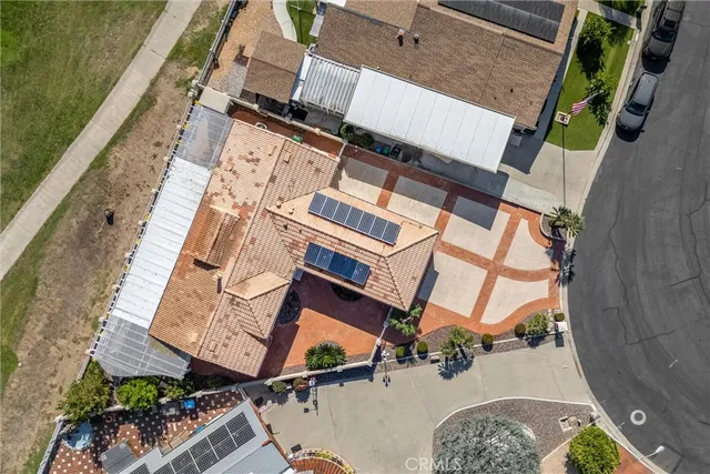 an aerial view of a house with a yard