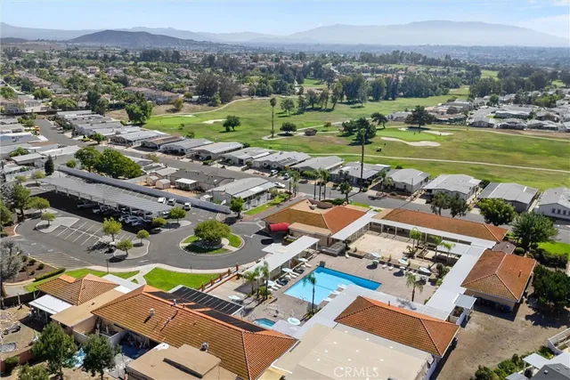 an aerial view of a city with lots of residential buildings and mountain view in back